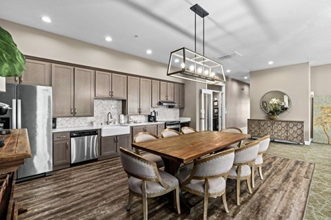 A modern kitchen with a wooden table and chairs.