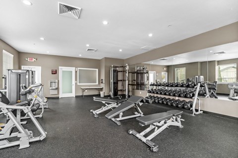 Fitness center with weights and exercise equipment at Fruitland Meadow Apartments, Salem