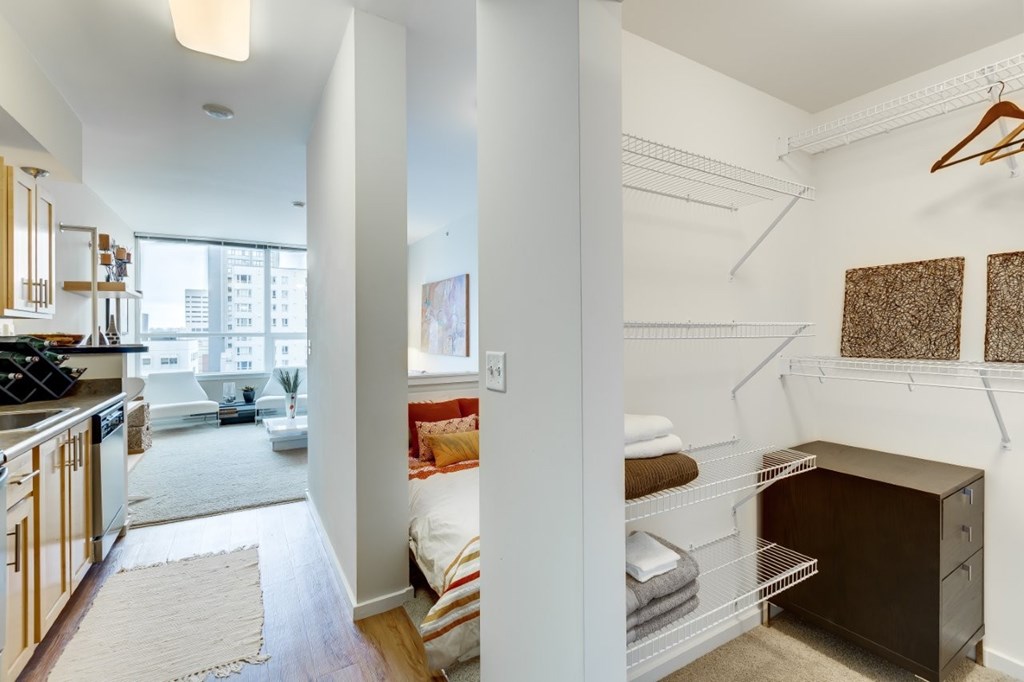 A white room with a brown cabinet and a white chair.