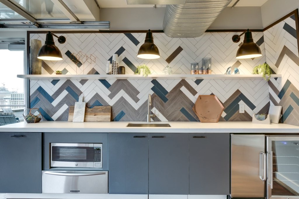 A modern kitchen with a stainless steel oven and a white countertop.