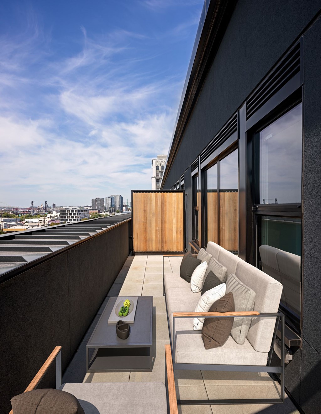 a living room with a couch and a coffee table on a balcony