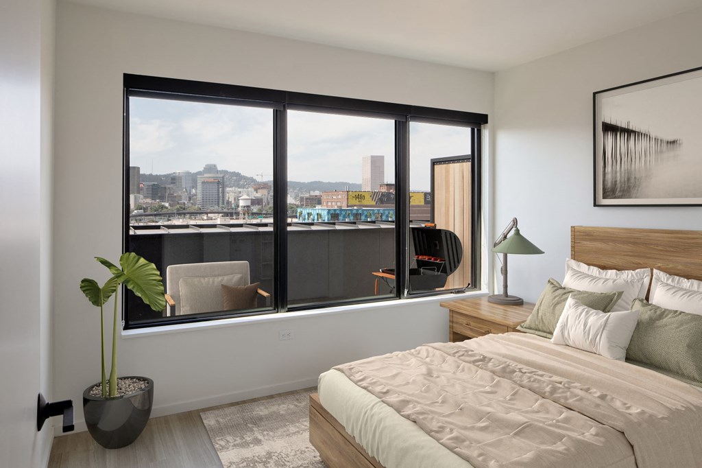 a bedroom with a bed and a large window