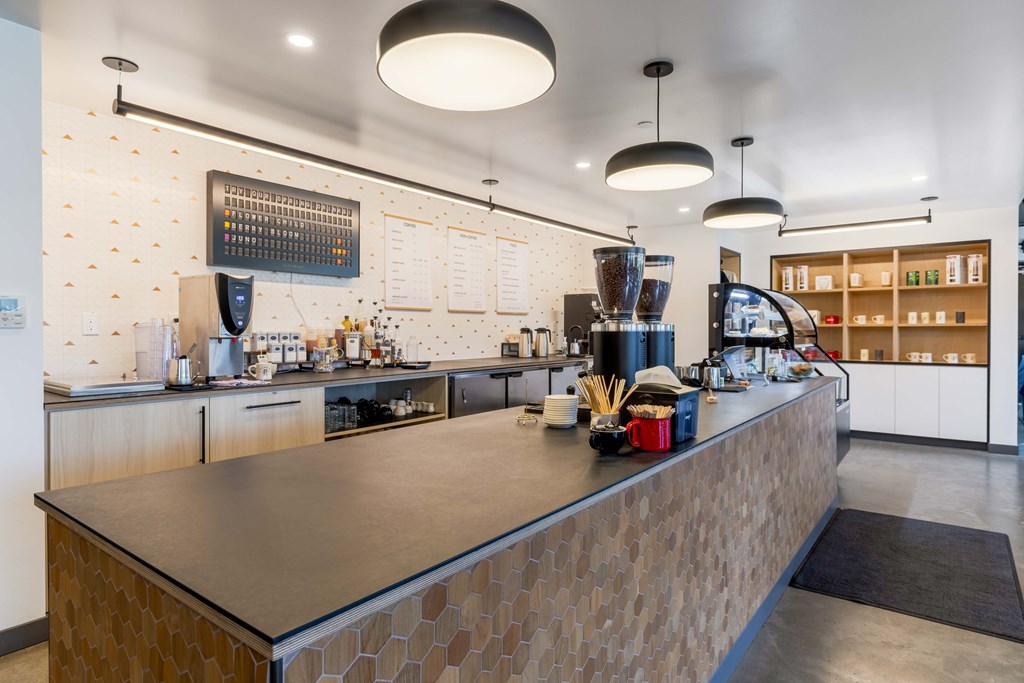 A modern coffee shop with a counter and a coffee machine.