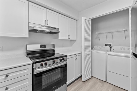 a white kitchen with white appliances and white cabinets