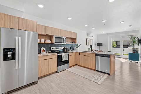 a kitchen with wooden cabinets and stainless steel appliances
