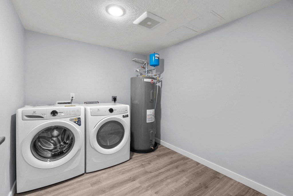 a laundry room with a washer and dryer and a water heater