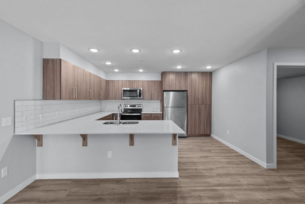 a kitchen with white countertops and wooden cabinets