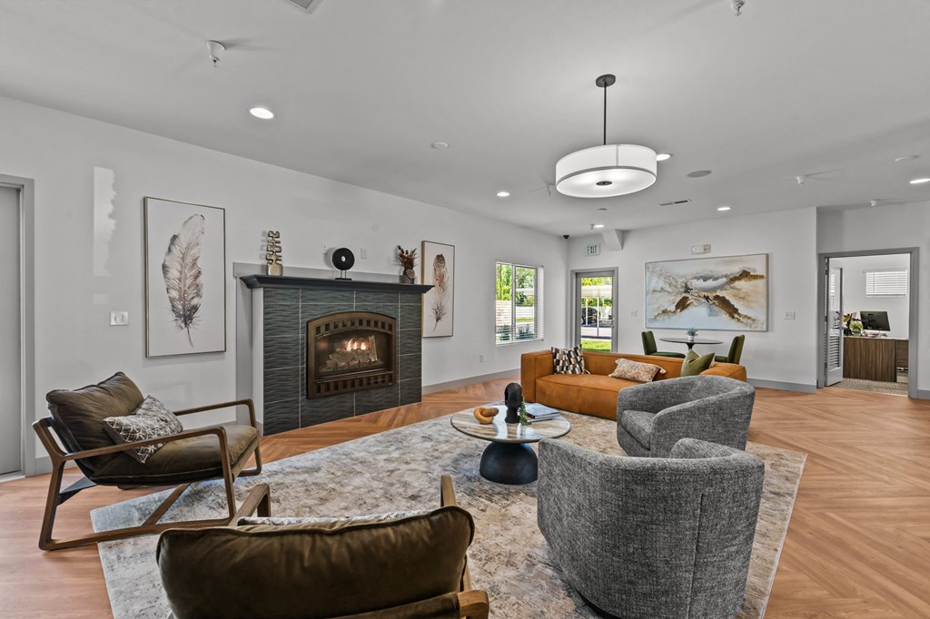 a living room with couches and chairs and a fireplace