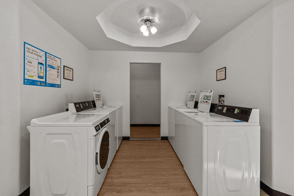 Curtis Apartments laundry room with washes and dryers