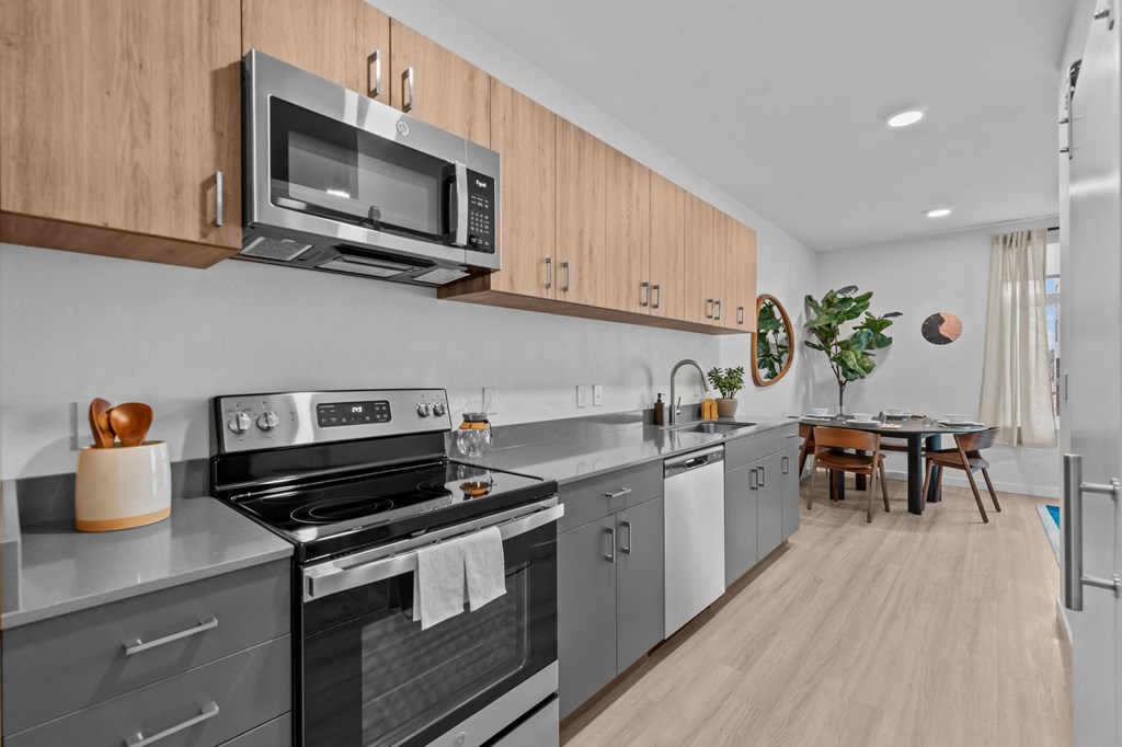 a kitchen with stainless steel appliances and wooden cabinets