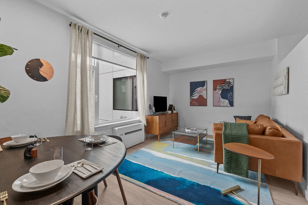 a living room with a table and a couch and a tv