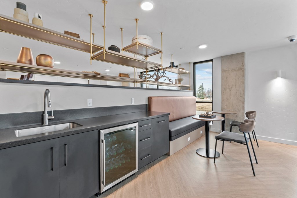 a kitchen with a sink and a bar and a living room with a couch