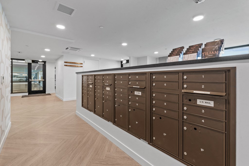 a lockers in a room with a wooden floor and white walls