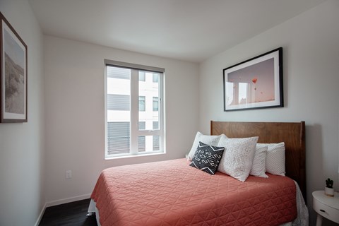 Grant Park Village bed with orange bedding with window