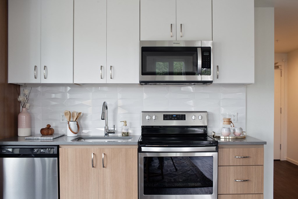 Grant Park Village kitchen shot showing while and natural wood cabinets