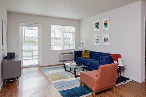 Grant Park Village living room shot with blue couch and orange leather chair
