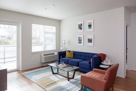Grant Park Village living room shot with blue couch and orange leather chair