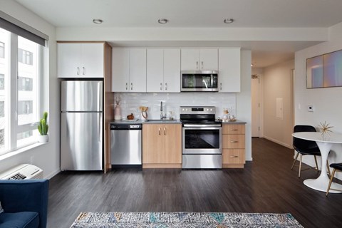 A modern kitchen with wooden cabinets and stainless steel appliances.