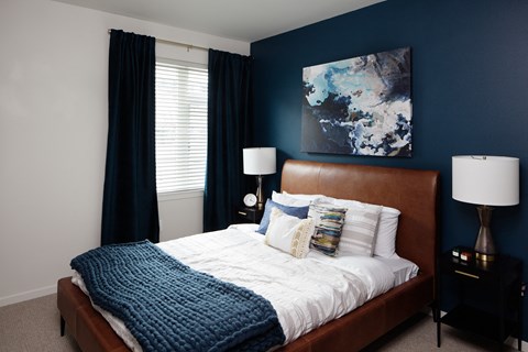 Grant park village bedroom shot of bed and blue accent wall