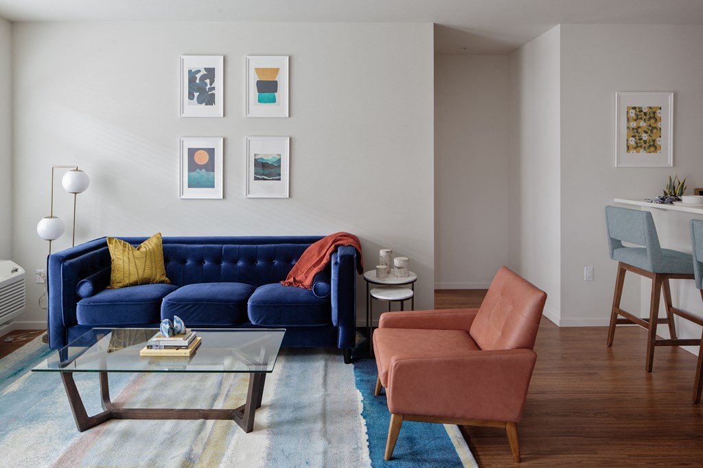 Grant Park village shot of coffee table and blue couch and orange chair
