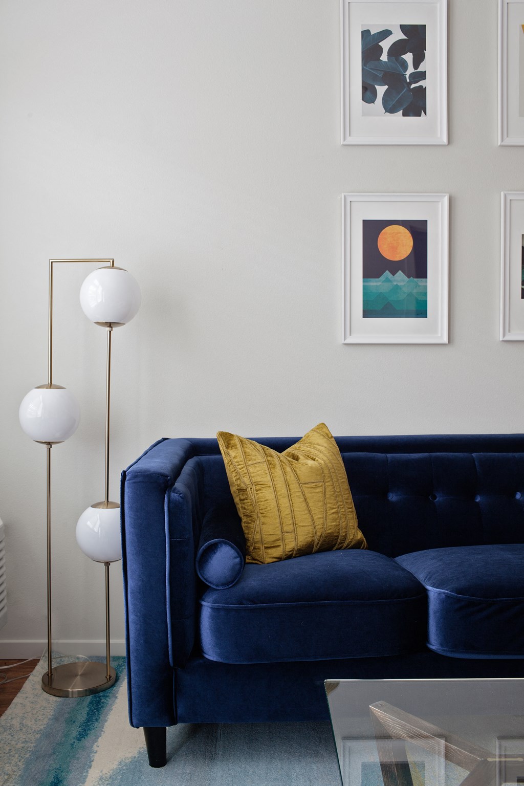 Grant park village shot of lights and art wall with blue velvet couch