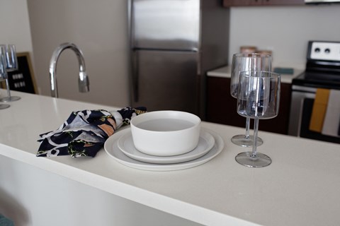 Grant park village shot of plates and wine glasses on kitchen bar