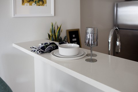 Grant park village shot of plates and wine glasses on kitchen bar