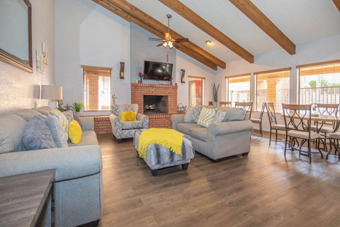 A living room with a grey couch and yellow throw pillows.