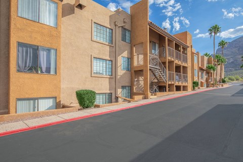 A street view of a residential area with apartment buildings.