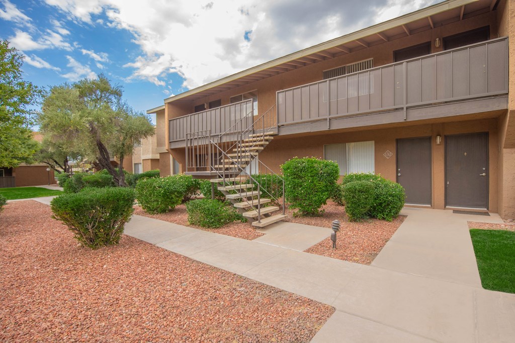 A building with a balcony and stairs leading to it.