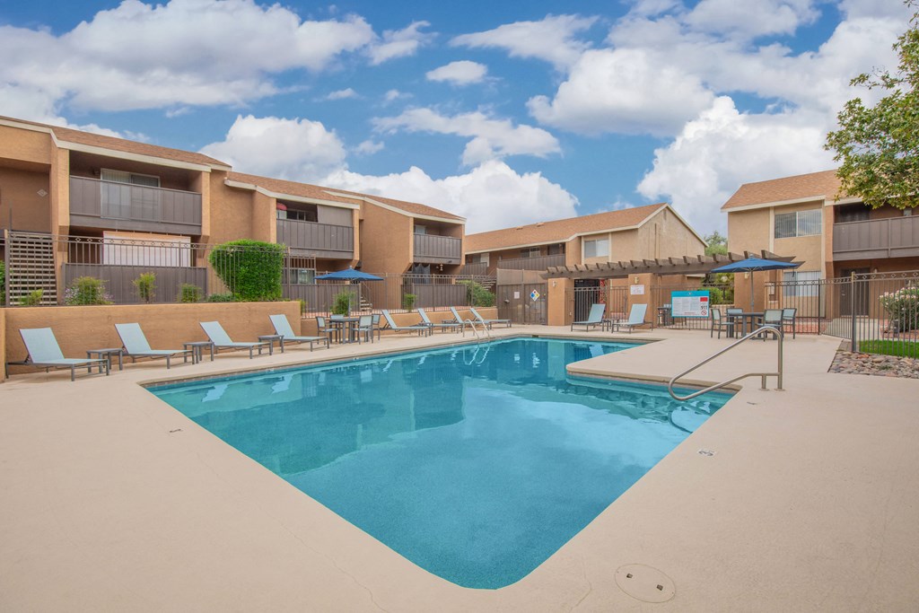 A large swimming pool in front of apartment buildings.