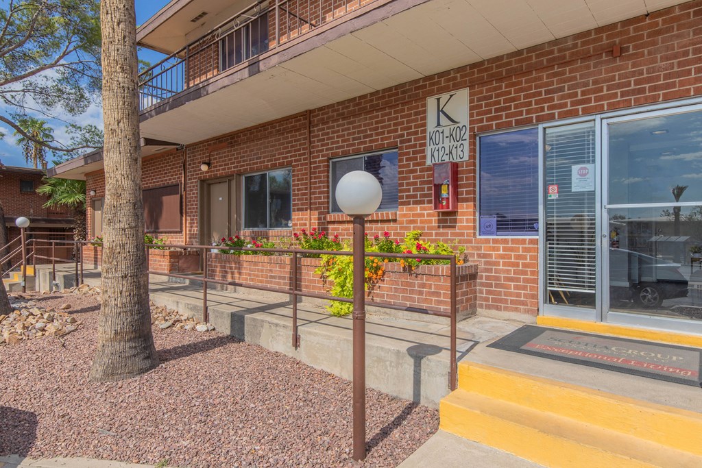 A building with a red brick exterior and a sign on the wall.
