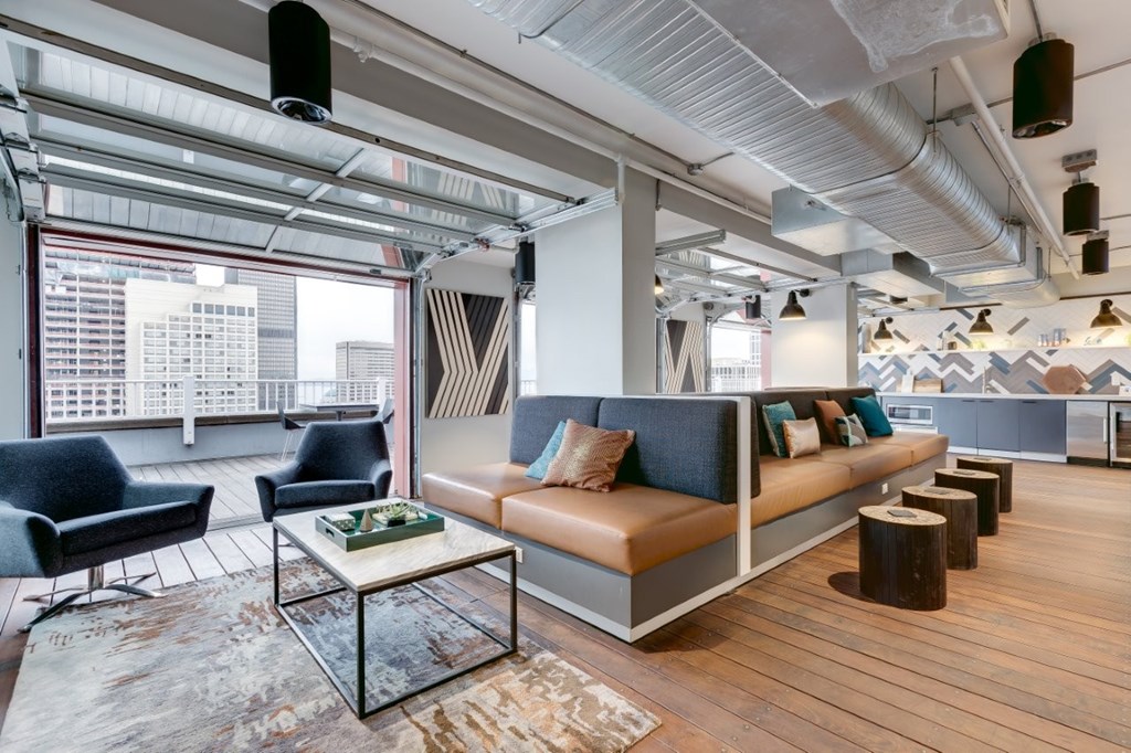 A modern living room with a large window and a view of the city.