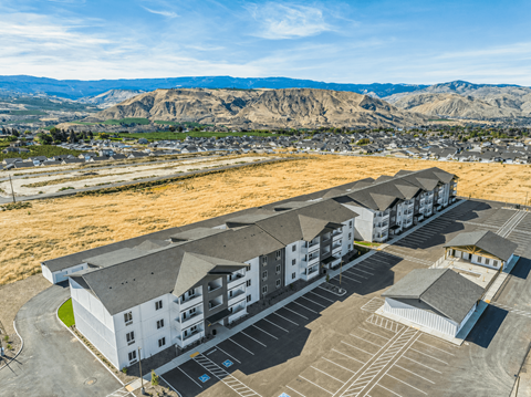 Aerial view of apartment complex with mountain backdrop at Gateway Apartments, East Wenatchee, WA 98802