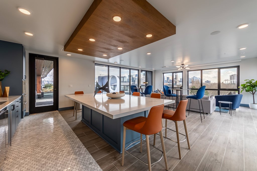 A modern kitchen with a large island and bar stools.