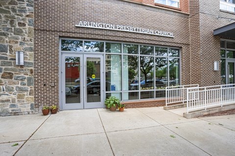 The front of Arlington Presbyterian Church with a sign above the door.