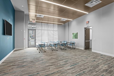 A conference room with a long table and chairs.