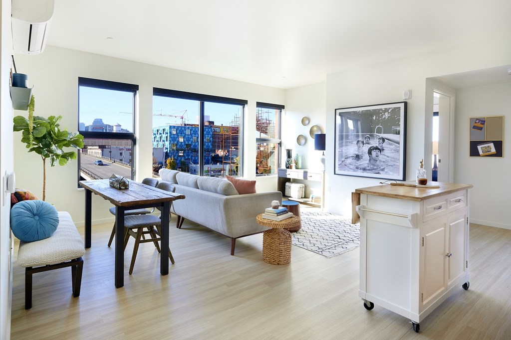 a living room with a couch and a table and a large window