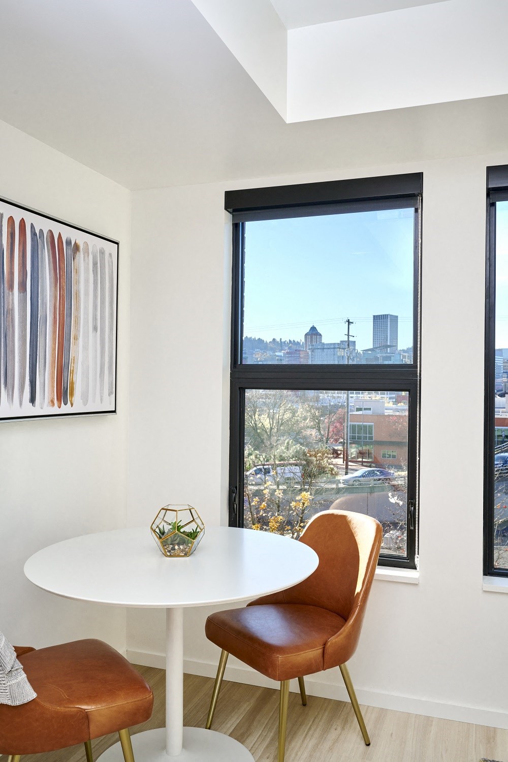 a dining room with a large window and a table and chairs