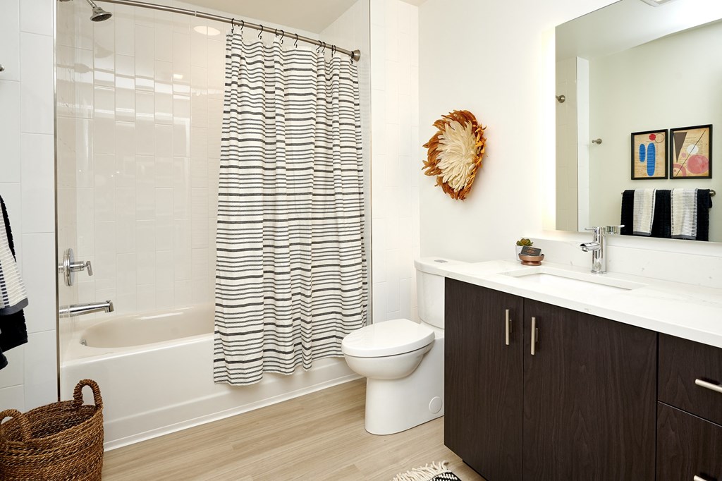 a bathroom with a shower and a sink and a toilet