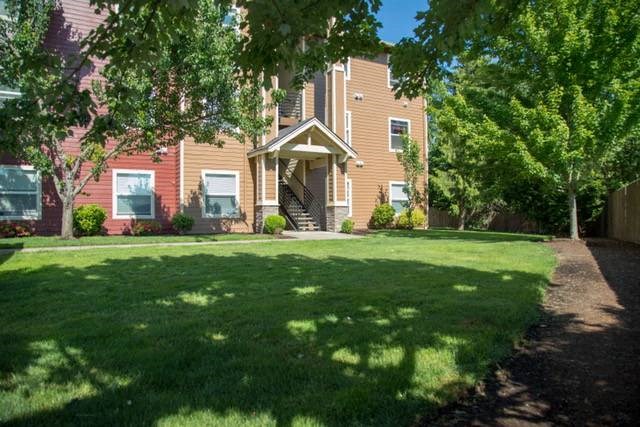 a large lawn in front of a brick house