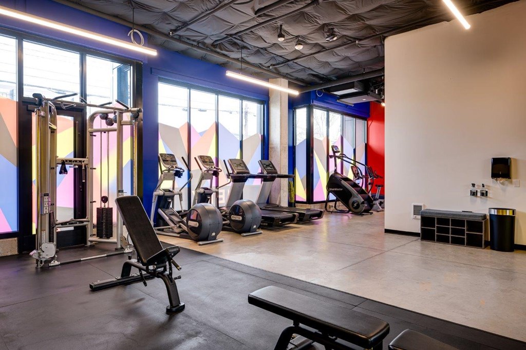 MERX Portland Oregon Apartments fitness center with a variety of equipment including treadmills, weights, and benches.