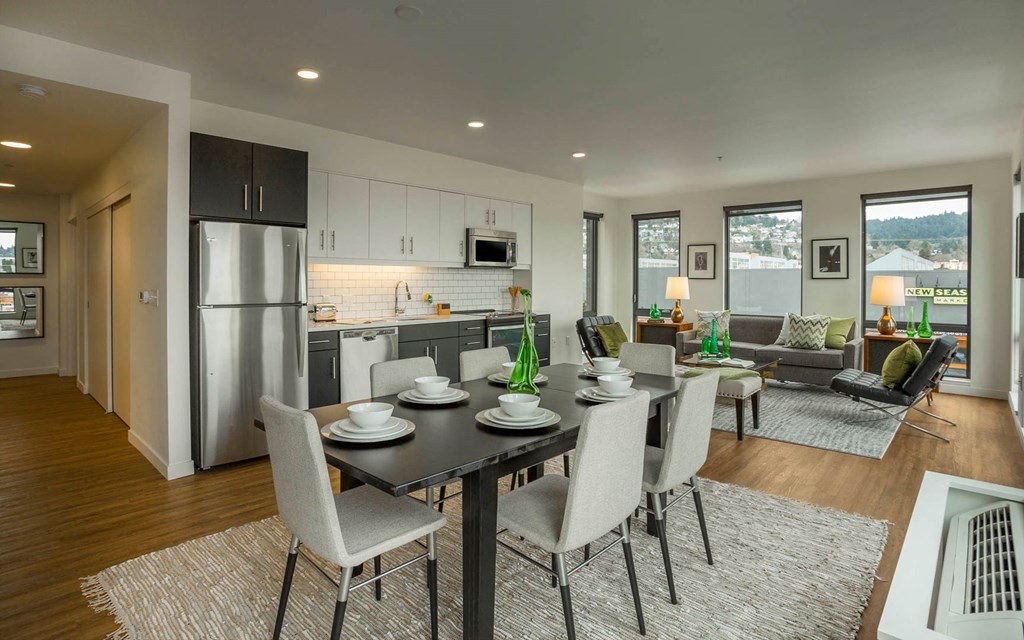 a kitchen and living room with a table and chairs