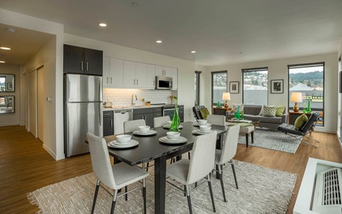 a kitchen and dining room with a table and chairs