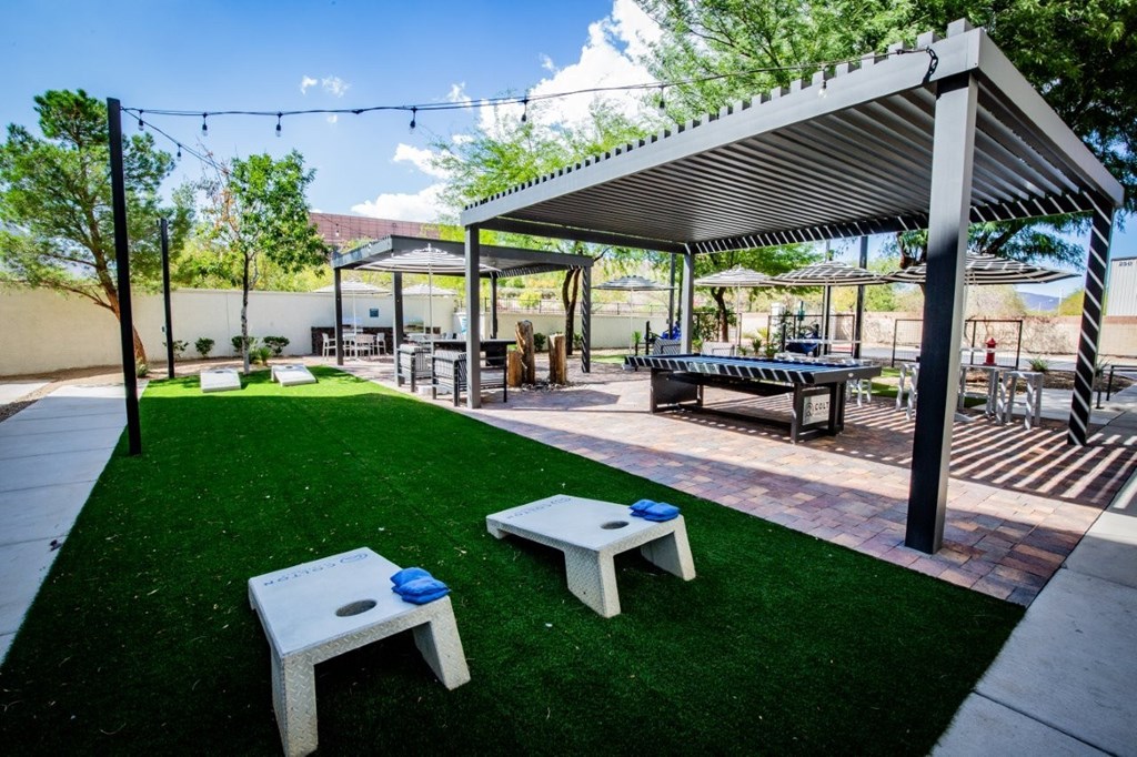 Colton Apartments A patio with a white table and a blue frisbee on it.