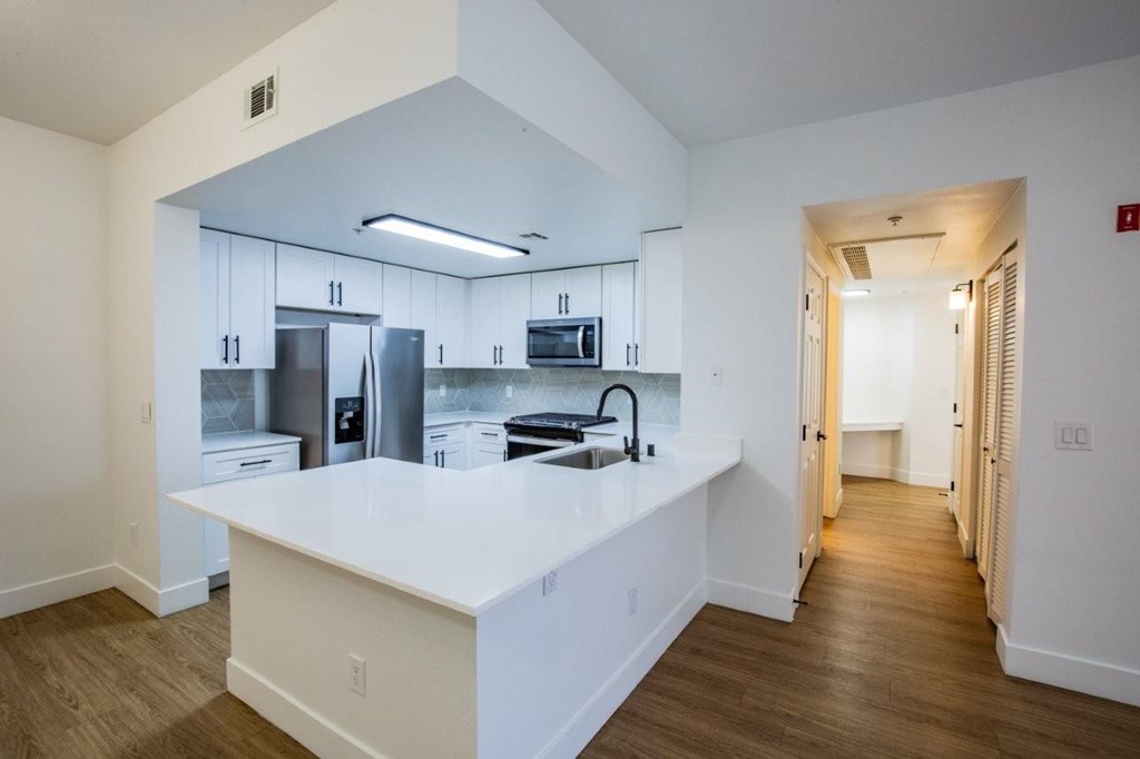 Colton Apartments  kitchen with whit countertops and stainless steel appliances
