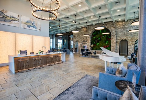 A reception area with a white piano and a reception desk.