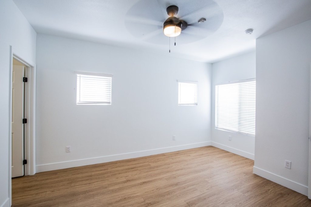 Colton Apartments   bedroom with wood floors and ceiling fan and windows
