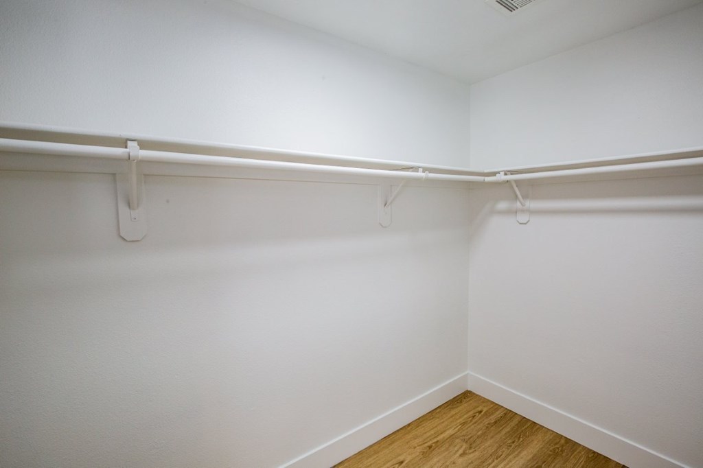 Empty room with white walls and wooden floor.