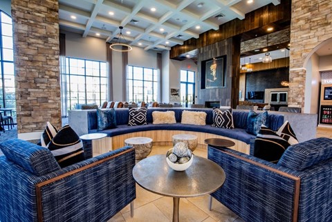 A living room with a stone pillar and a blue couch.